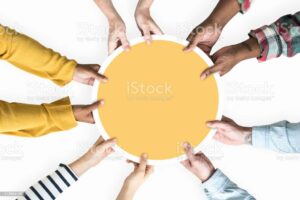 Diverse hands supporting a blank yellow round board